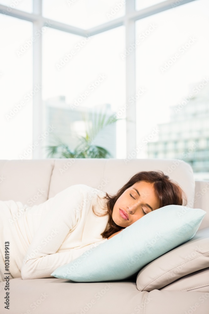 Beautiful brunette taking a nap lying on the couch Beautiful brunette taking a nap lying on the couch