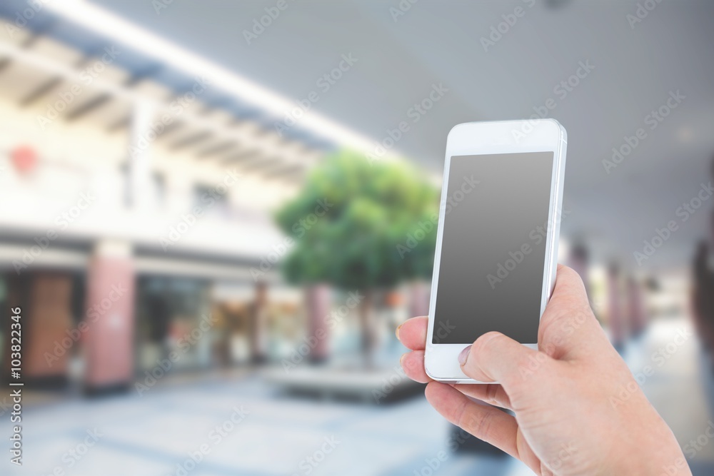 Composite image of woman showing smartphone 