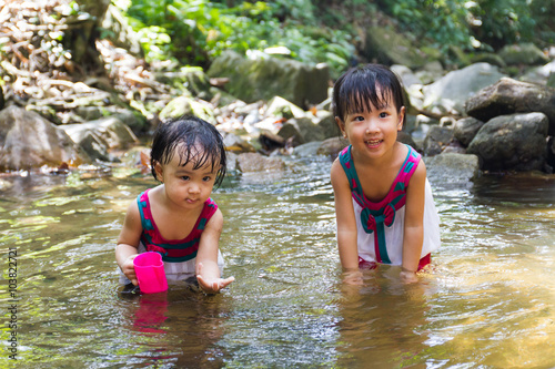 Asian Little Chinese Girls Playing in Creek