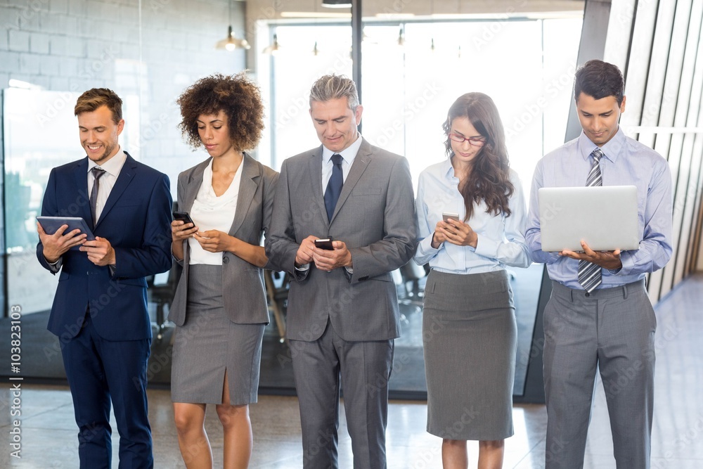 Businesspeople using mobile phone, lap top and digital tablet Businesspeople using mobile phone, lap top and digital tablet