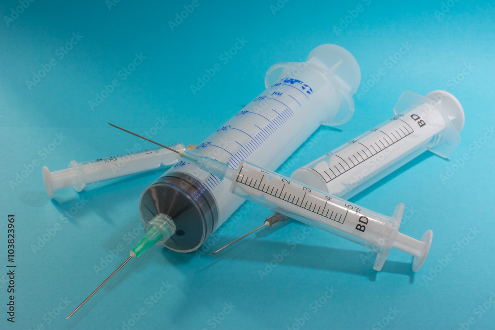 syringes on a blue background, scattered syringes on a blue background, scattered