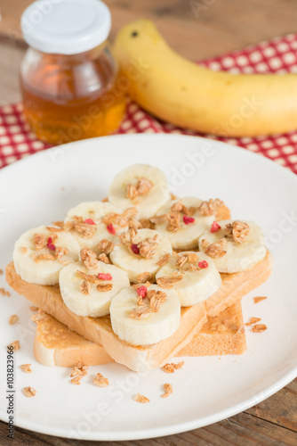 A healthy peanut butter and banana sandwich, muesli crisp with berry.
