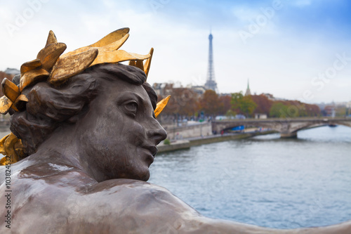 Sculpture in the Alexandre III bridge and Eiffel tower in Paris, France © Javi Martin