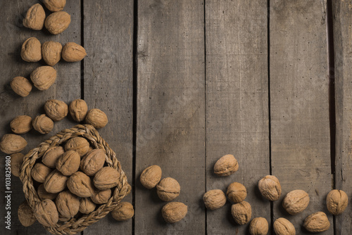 Old wooden background with walnuts