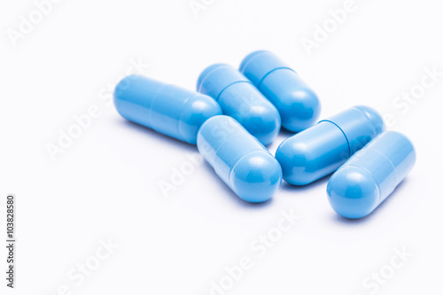 Blue pills isolated on white.