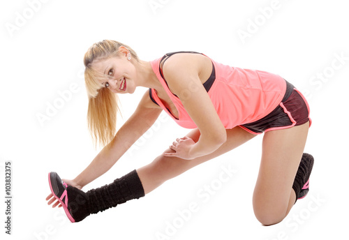 Fit woman stretching her leg to warm up