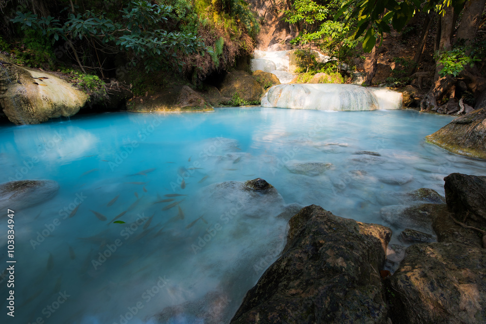 Water fall in the forest with blue water.