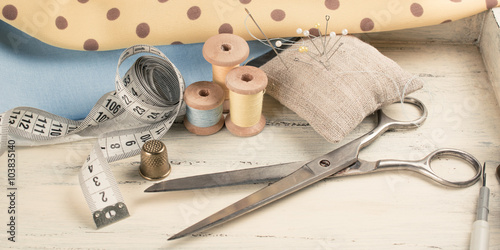 Set of reel of thread, scissors, fabric and pins for sewing and