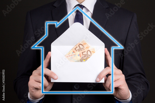 real estate and mortgage concept - envelope with money in busine