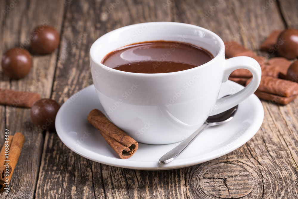 White cup of delicious hot chocolate with candies on table. White cup of delicious hot chocolate with candies on table.