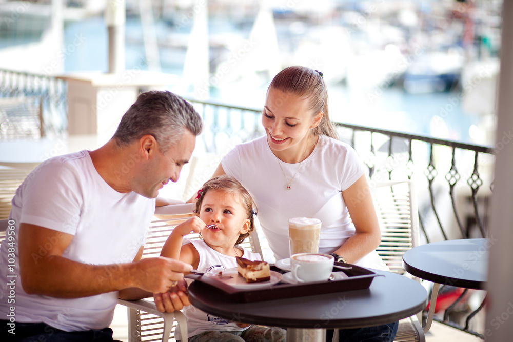 Girl with parents at a cafe
