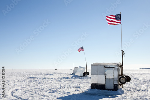 Ice Shanties on Frozen Lake with American Flags photo