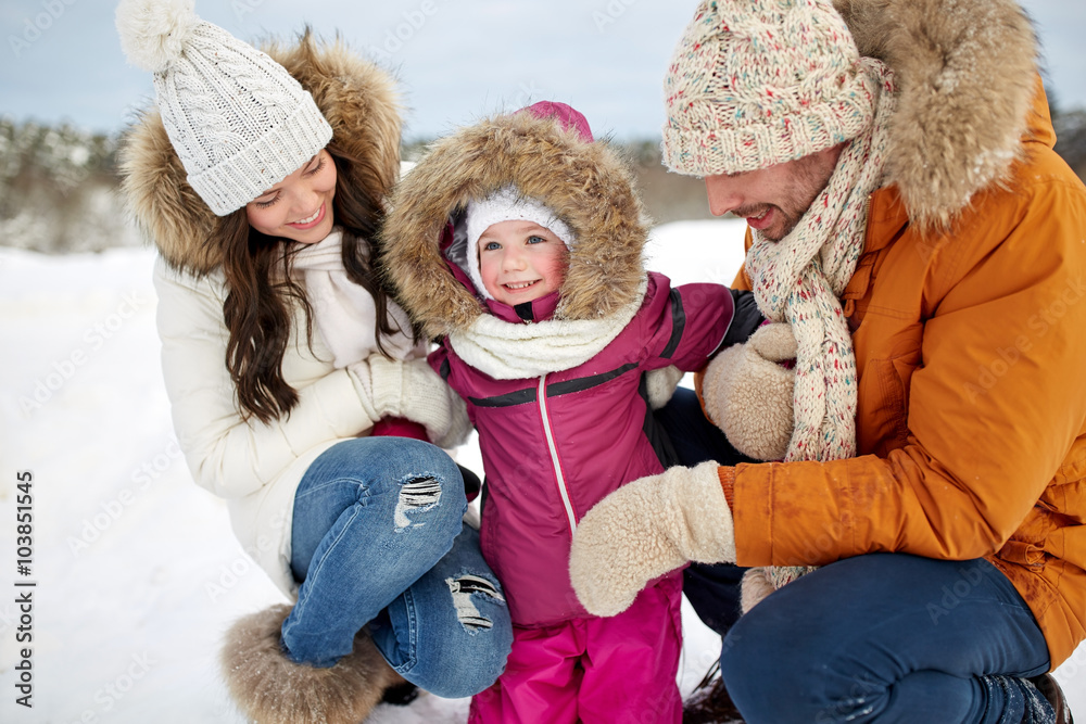 Obraz premium happy family with child in winter clothes outdoors