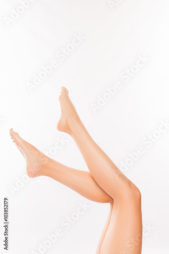 Close up photo of perfect smooth woman's legs on white backgroun