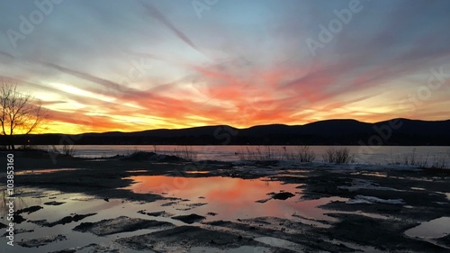 Sunset over frozen Pontoosuc Lake at Pittsfield, MA. photo