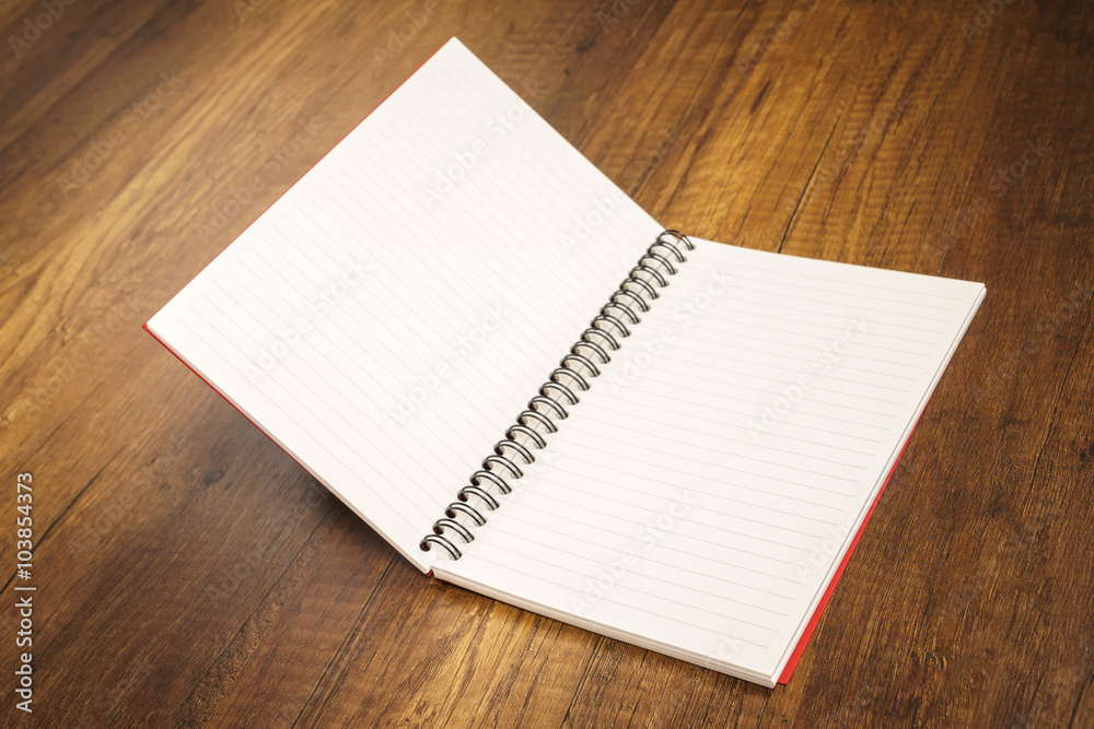 Note book on a wooden desk Note book on a wooden desk