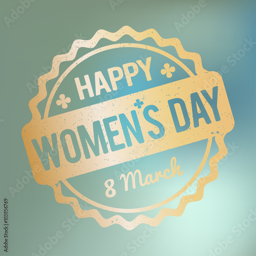 Happy Women's Day rubber stamp gold on a blue bokeh fog background.
