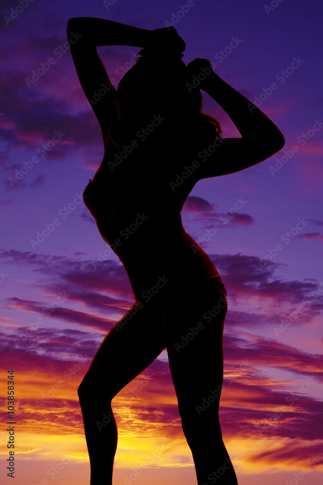silhouette woman in pink swimsuit hips back chest out