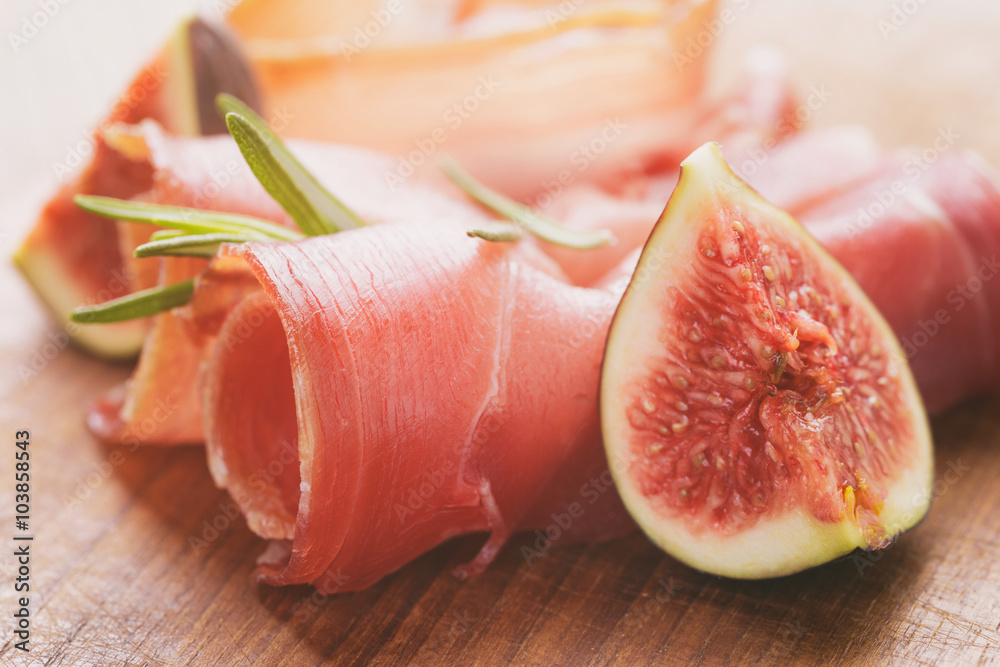 dried jamon slices with figs on wood table, spanish traditional food dried jamon slices with figs on wood table, spanish traditional food