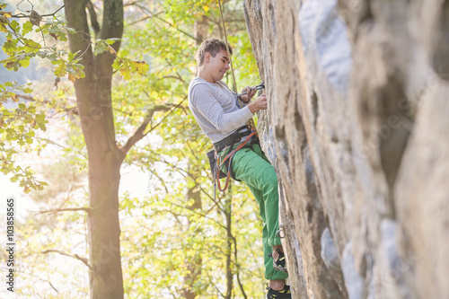 Young climber on a rocky wall