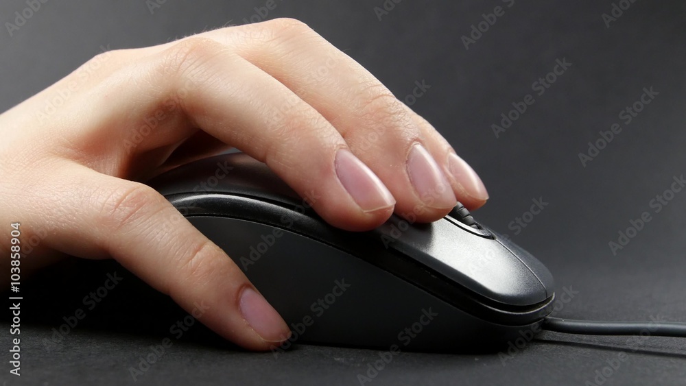 Person hand on mouse, black, side view Person hand on mouse, black, side view