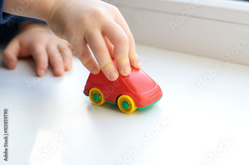Little child hand close up playing toy