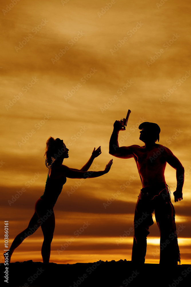 silhouette of a woman standing and reaching forward with both ha