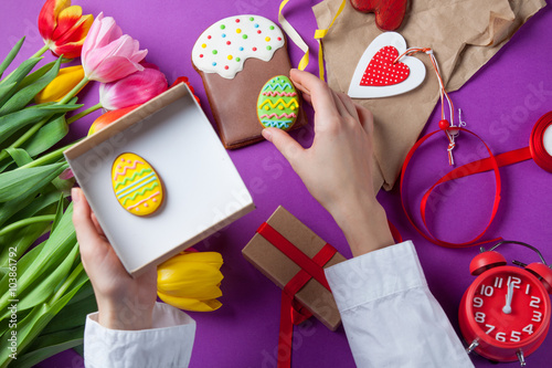 hands are holding a gift box with Easter eggs