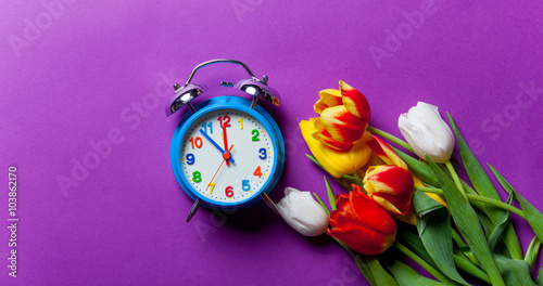 Beautiful bouquet of tulips and clock