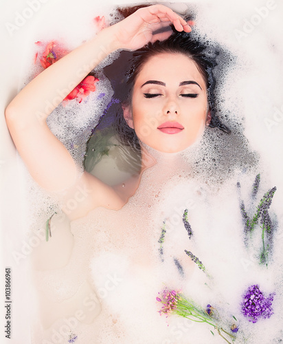 woman with flowers in the foam bath