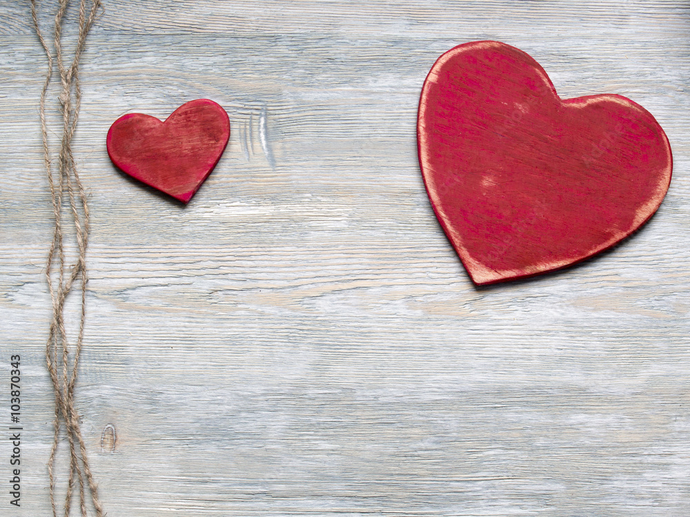 Two wood valentine's hearts lie on rustic wood texture backgroun Two wood valentine's hearts lie on rustic wood texture backgroun