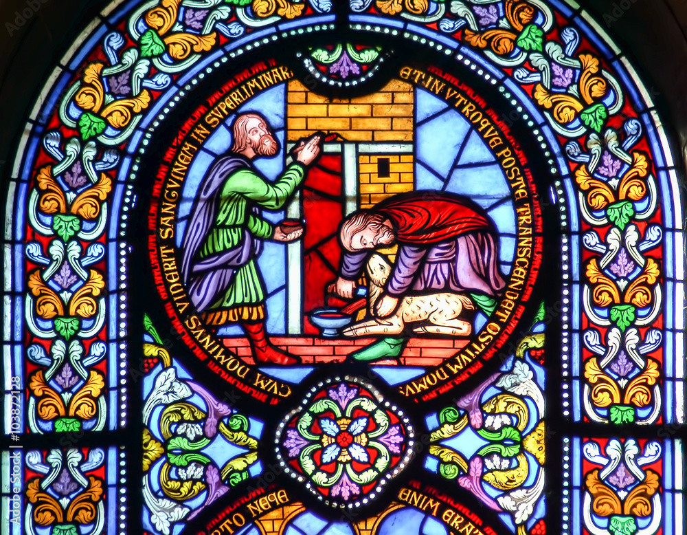 Stained glass window depicting sacrificing the lamb Stained glass window depicting sacrificing the lamb