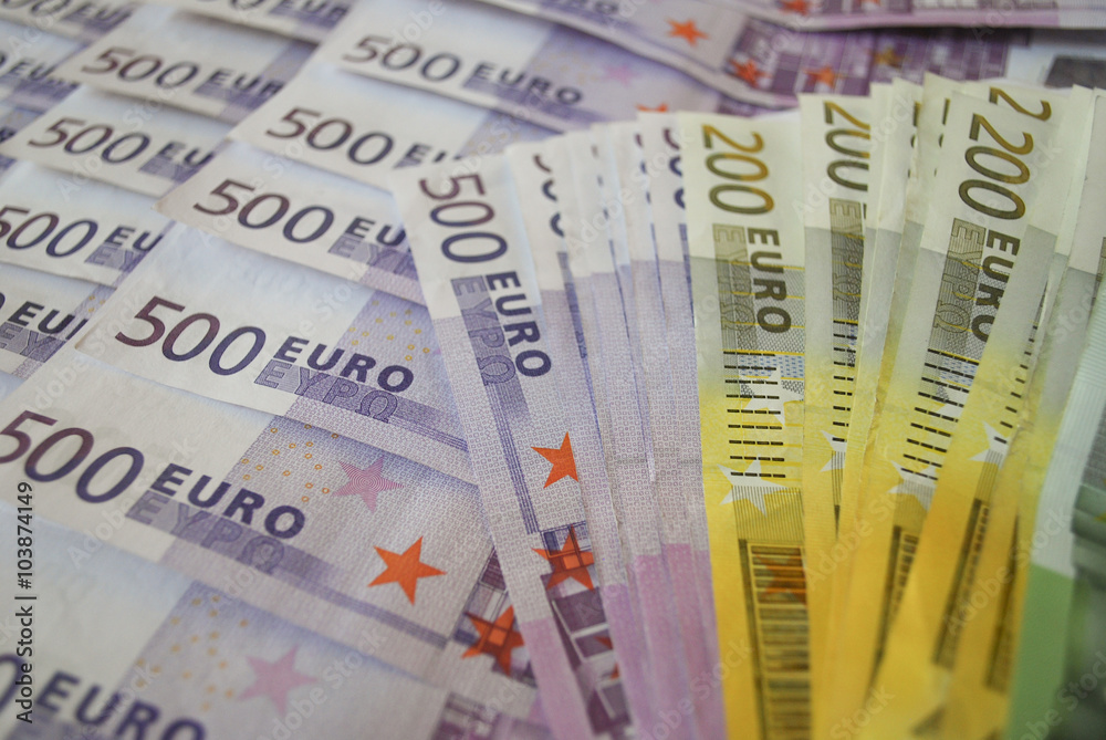 Cash Euro five hundred banknotes spread out on the table.