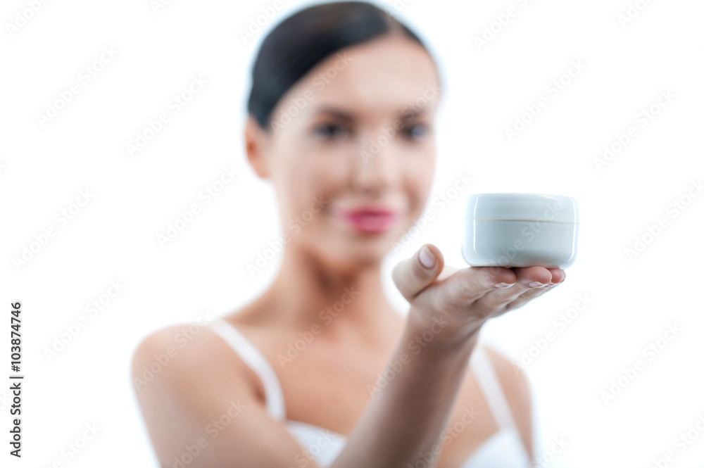 Pretty young woman is presenting great moisturizer