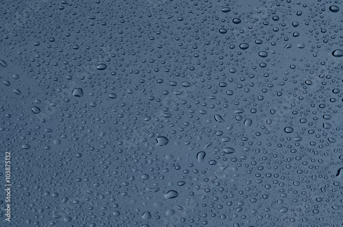 Drops on glass, a grey-blue background