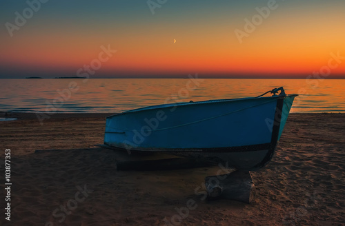 Boat on the beach at sunset background