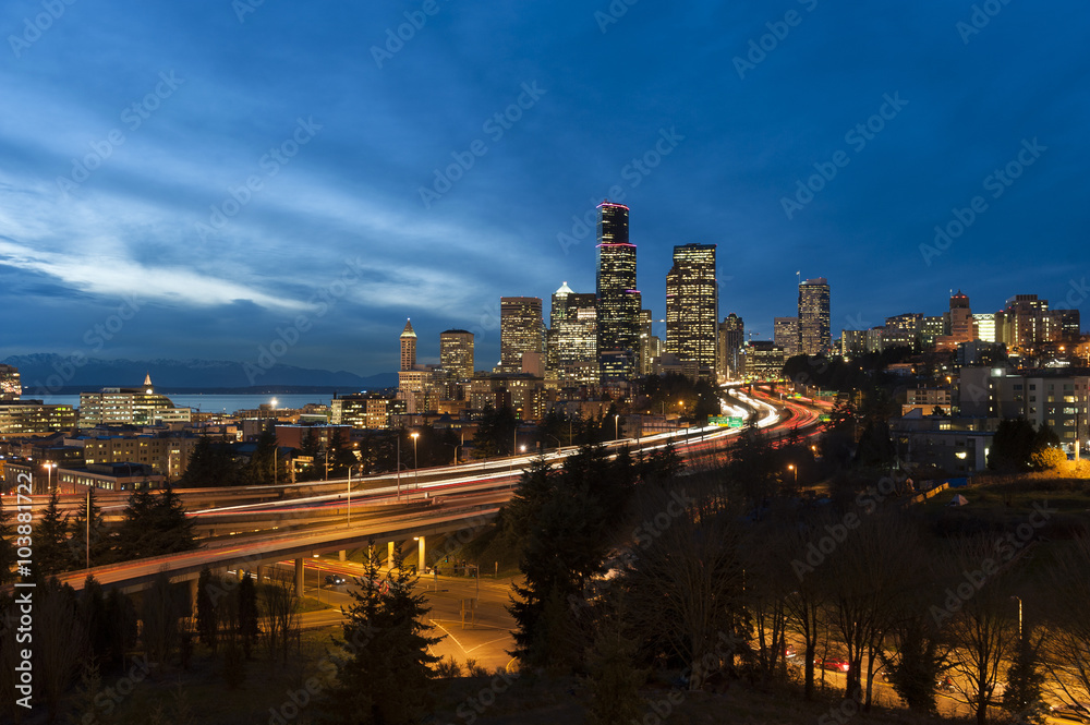 Seattle Skyline. Commuters head home during rush hour treated to a lovely sunset over Elliott Bay and the Puget Sound area of the Pacific Northwest.