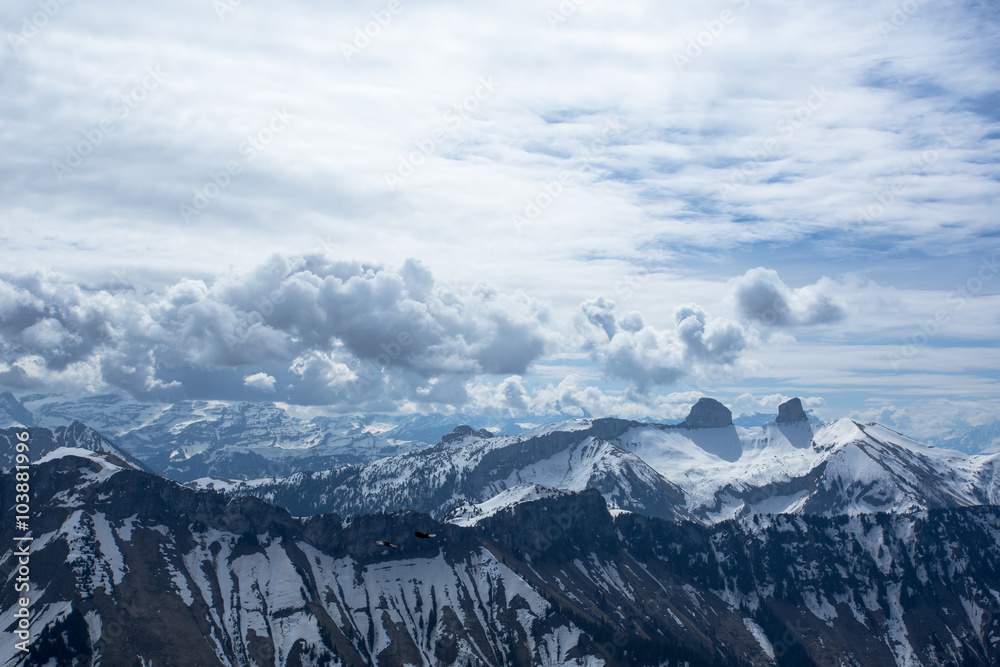 Large clouds over the Swiss Alps, looking from a mountain near Montreux called Rochers-de-Naye. As seen from the distance, there are two summits called Tour de Mayen and Tour d'Ai. Large clouds over the Swiss Alps, looking from a mountain near Montreux called Rochers-de-Naye. As seen from the distance, there are two summits called Tour de Mayen and Tour d'Ai.
