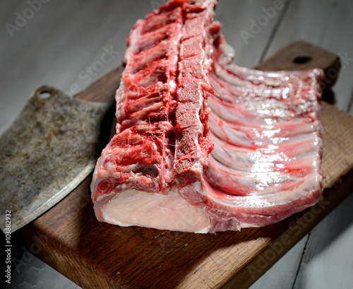 raw pork steak on a wooden background