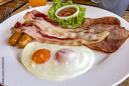 English breakfast with fried eggs, sausages and bacon