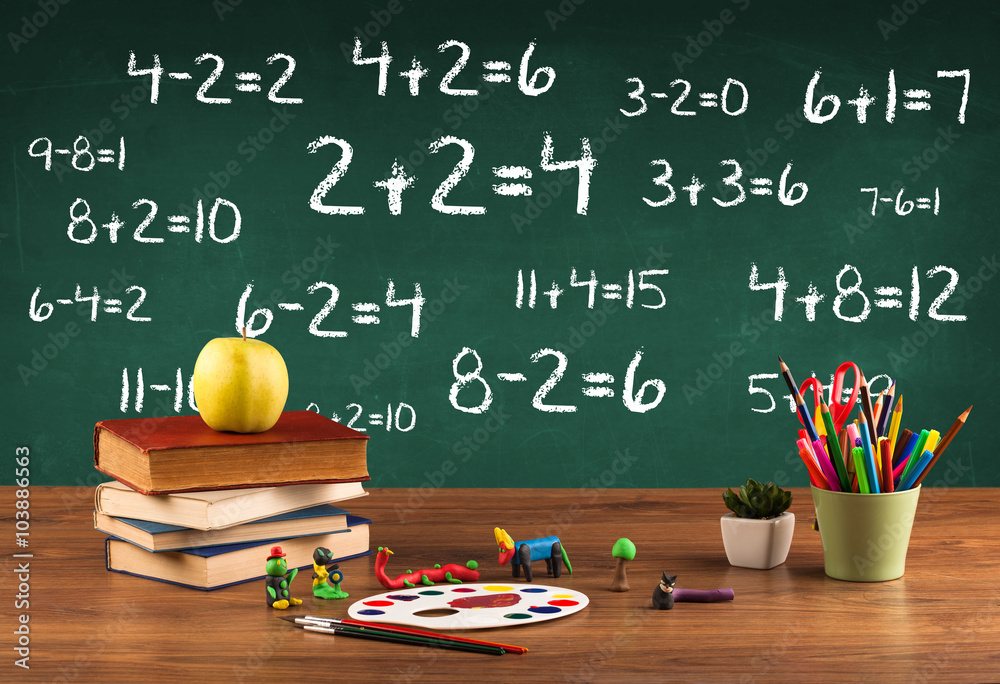 School blackboard with pile of books