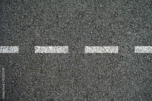 The lines on the asphalt road surface.