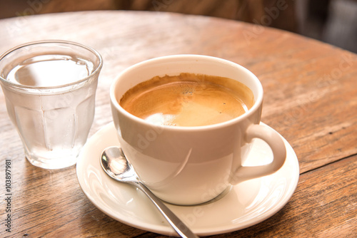 Coffee,White Coffee Mug,Glass water,Wooden table.