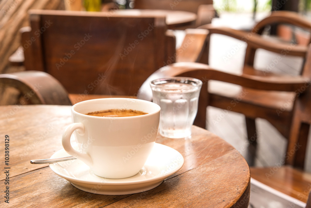 Coffee,White Coffee Mug,Glass water,Wooden table. Coffee,White Coffee Mug,Glass water,Wooden table.
