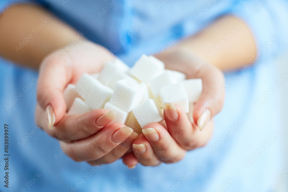 Woman with cubes of white sugar Woman with cubes of white sugar