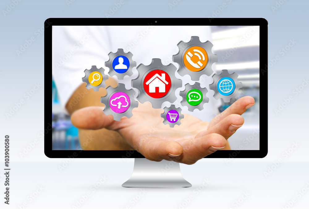 Businessman escaping from computer holding cogwheels in his hand Businessman escaping from computer holding cogwheels in his hand