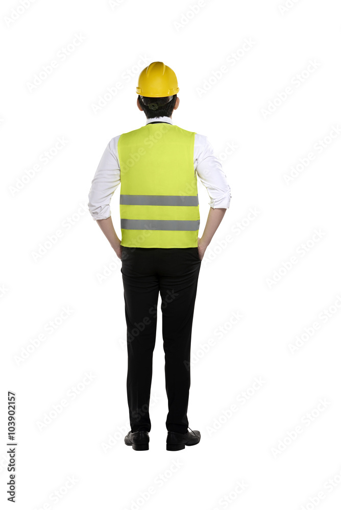 Back view of asian worker wearing safety vest and yellow helmet