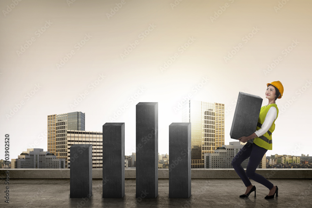 Asian business woman lifting block of chart Asian business woman lifting block of chart