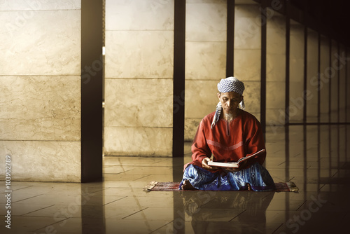 Bild auf Leinwand Religious muslim man reading holy koran