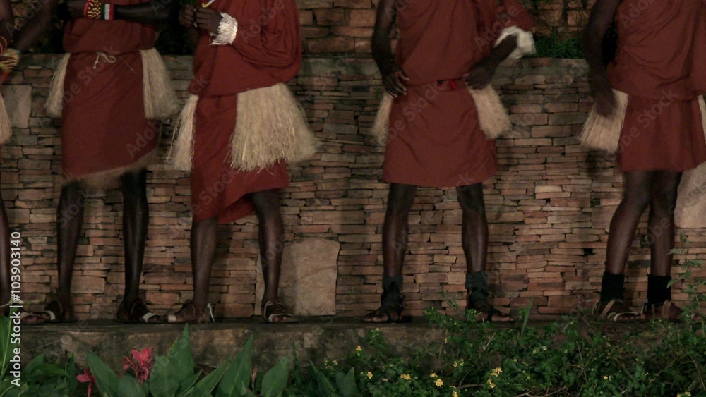 Uganda, OCTOBER 2015: Legs of African tribe dancers performing, traditionally dressed African tribesmen and tribeswomen dance and sing songs, drumming, jumping, clapping & singing happy group. Uganda, OCTOBER 2015: Legs of African tribe dancers performing, traditionally dressed African tribesmen and tribeswomen dance and sing songs, drumming, jumping, clapping & singing happy group.